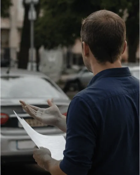 Driver next to his parked car, clearing up a question over the phone